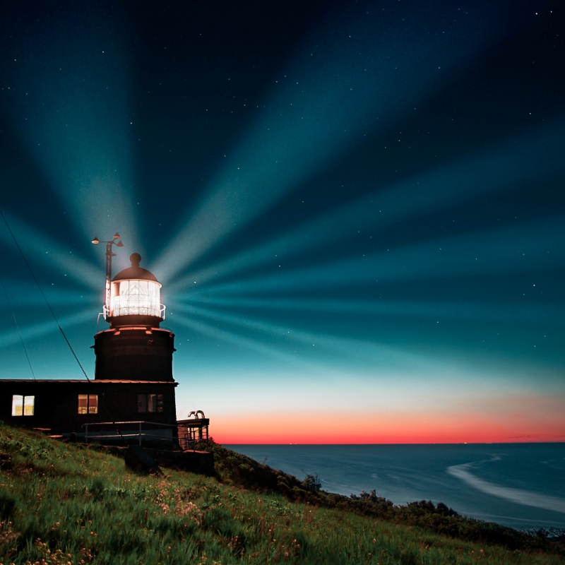 Lighthouse beams light over ocean